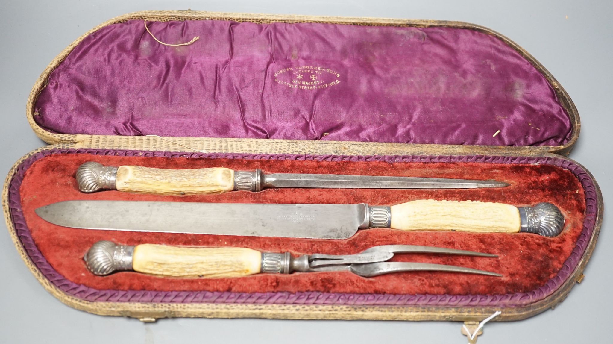 A stag horn handled three piece carving set, cased
